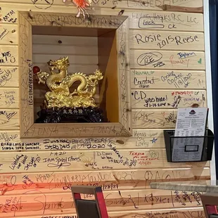 a wooden wall with writing on it