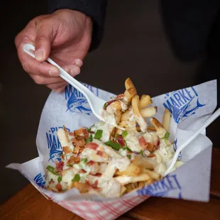 Hot fries smothered in award-winning clam chowder topped with bacon and onions
