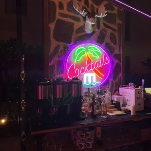 a neon sign for a cocktail bar
