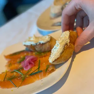 a person picking up a piece of bread