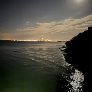 a full moon over the water