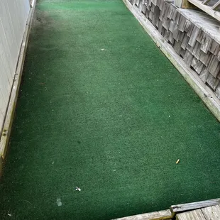 Filth and cigarette butt on the putt putt.