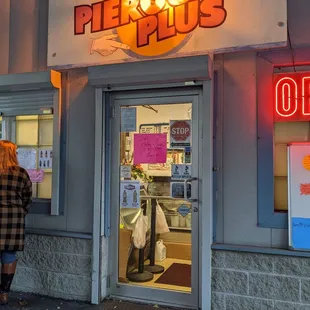 a woman standing in front of a restaurant