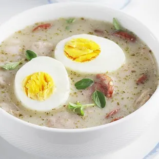 a bowl of soup with hard boiled eggs