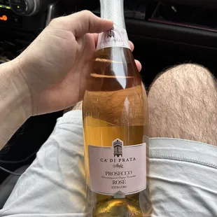 a person holding a bottle of wine