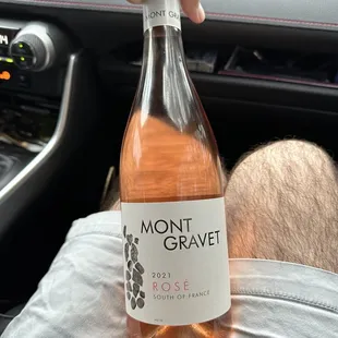 a person holding a bottle of wine