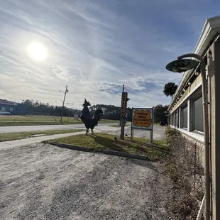 a rooster standing in front of a restaurant