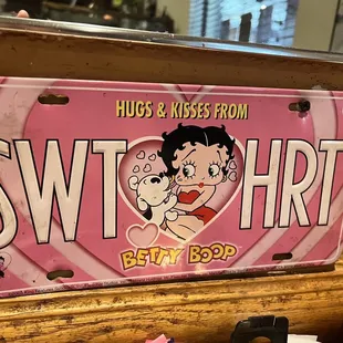 a pink license plate with a cartoon character