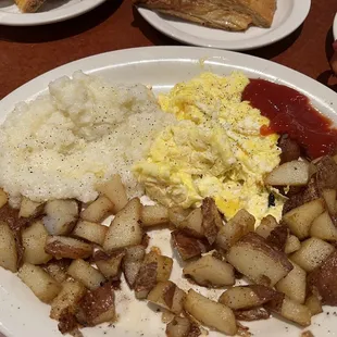 Two egg combo with home fries, onions, and a side of grits