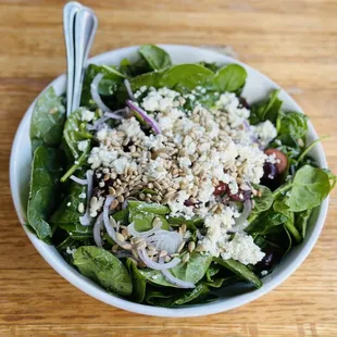 a bowl of spinach salad