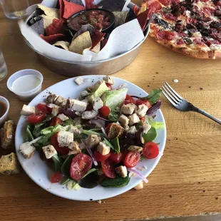 Small salad , pizza , and a side of chips and salsa.