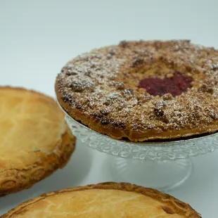 three pies on a white surface