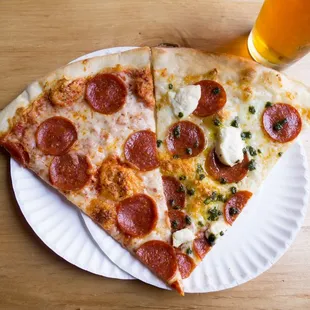 two slices of pizza on a paper plate