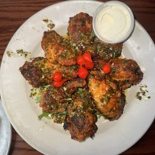 Wings with dry rub topped with peppers and chimichurri