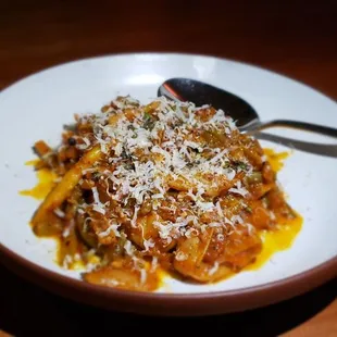 a plate of pasta with a spoon