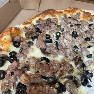 White pizza with extra sausage mushroom and black olive