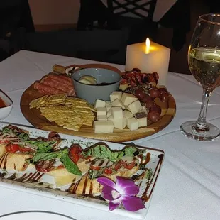 Charcuterie board and caprese salad with reisling.