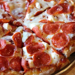 PEPPERONI CREAM CHEESE PIZZA: A thick blanket of spicy pepperoni covering mozzarella on top of silky cream cheese.