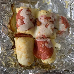 Loaded breadsticks: bites with pepperoni sitting on top...of some of them
