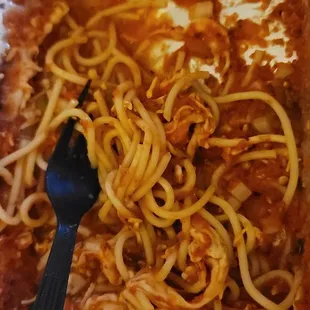 a piece of pizza with spaghetti and sauce