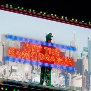 a neon sign in front of a cityscape