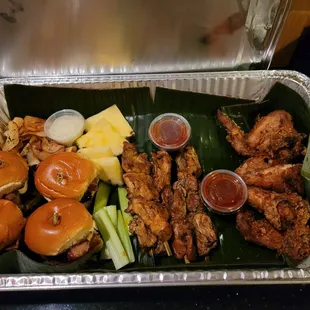 a platter of food on a banana leaf