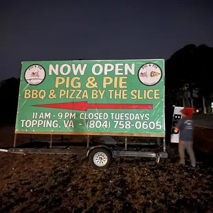 a man standing next to a sign
