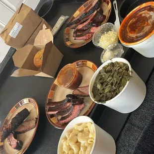 Beef Brisket - 1 lb. Baby Back Ribs - 1 lb. White Cheddar Mac N Cheese - Medium 16oz Collard Greens with Ham Hock - Medium (16oz.)