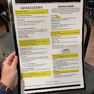 a person holding a menu