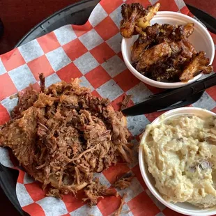 Pulled pork and brisket with a side of garlic cauliflower and loaded potato salad.