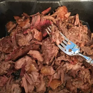 a fork in a pan of pork