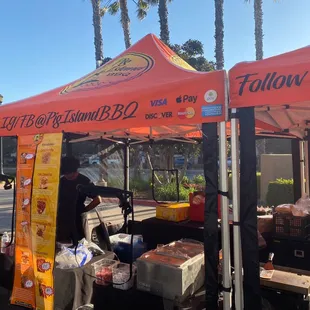 a man selling food under a tent