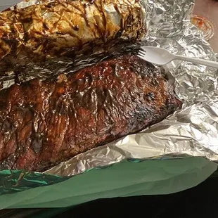 Ribs (slab for one served wet), fried, hush puppies, and very buttery garlic toast.