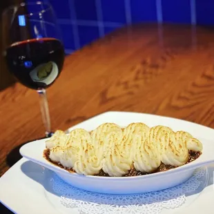 plate of food and a glass of wine