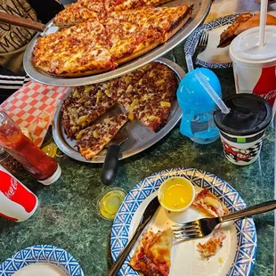 Pepperoni pizza, gluten free pineapple bacon pizza on bottom.