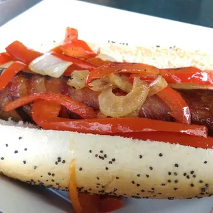 The OG (bacon wrapped hot dog topped with grilled peppers and onions)