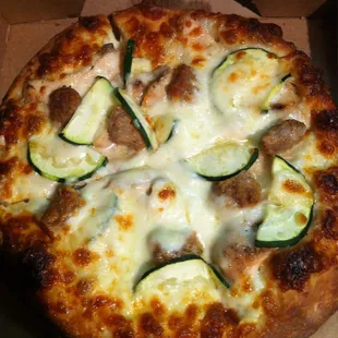 White Pizza. Alfredo sauce, chicken, zucchini and sausage. Yum!!