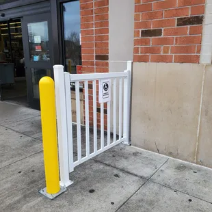 a white fence and a yellow pole