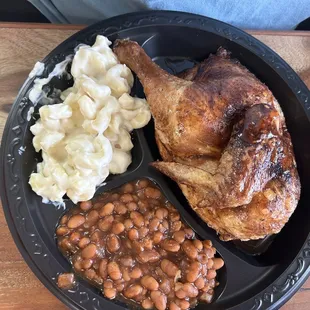 Half Chicken Plate with baked beans and Macaroni and cheese.