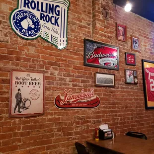 a brick wall with various signs
