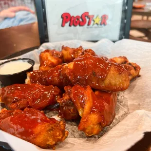 a plate of chicken wings and dipping sauce