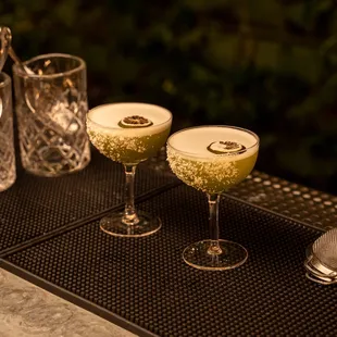 two cocktail glasses on a table