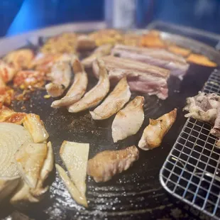 Beef, pork, onion, kimchi, bean sprouts, mushrooms, sweet potatoes cooking!