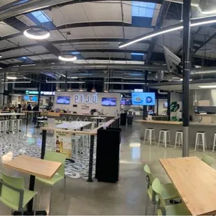Piju social hour inside Cravings food market and in the center with 3 TVs and great seating
