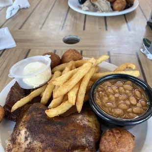 Smoked Chicken, pork chop, fries, beans and hush puppies  Rear plate; pulled pork and brisket potatoe salad and slaw