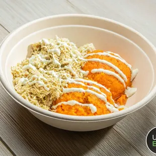 a bowl of food on a wooden table