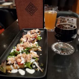 a plate of food and a glass of beer