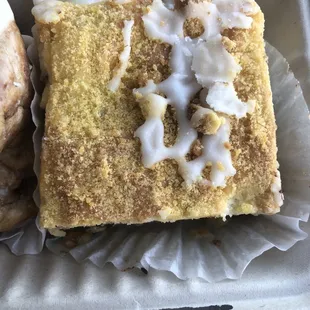 a pastry and a donut in a styrofoam container