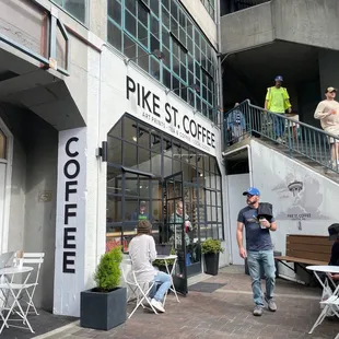 people sitting outside of a coffee shop