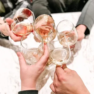 a group of people clinking wine glasses